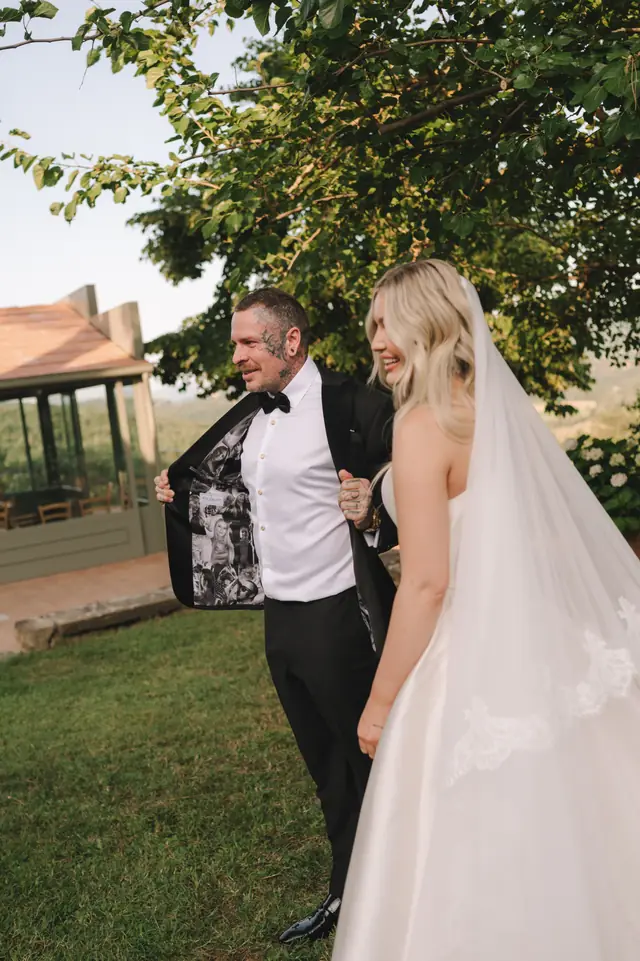 Anthony shows the photographic lining of his jacket beside Isabella.
