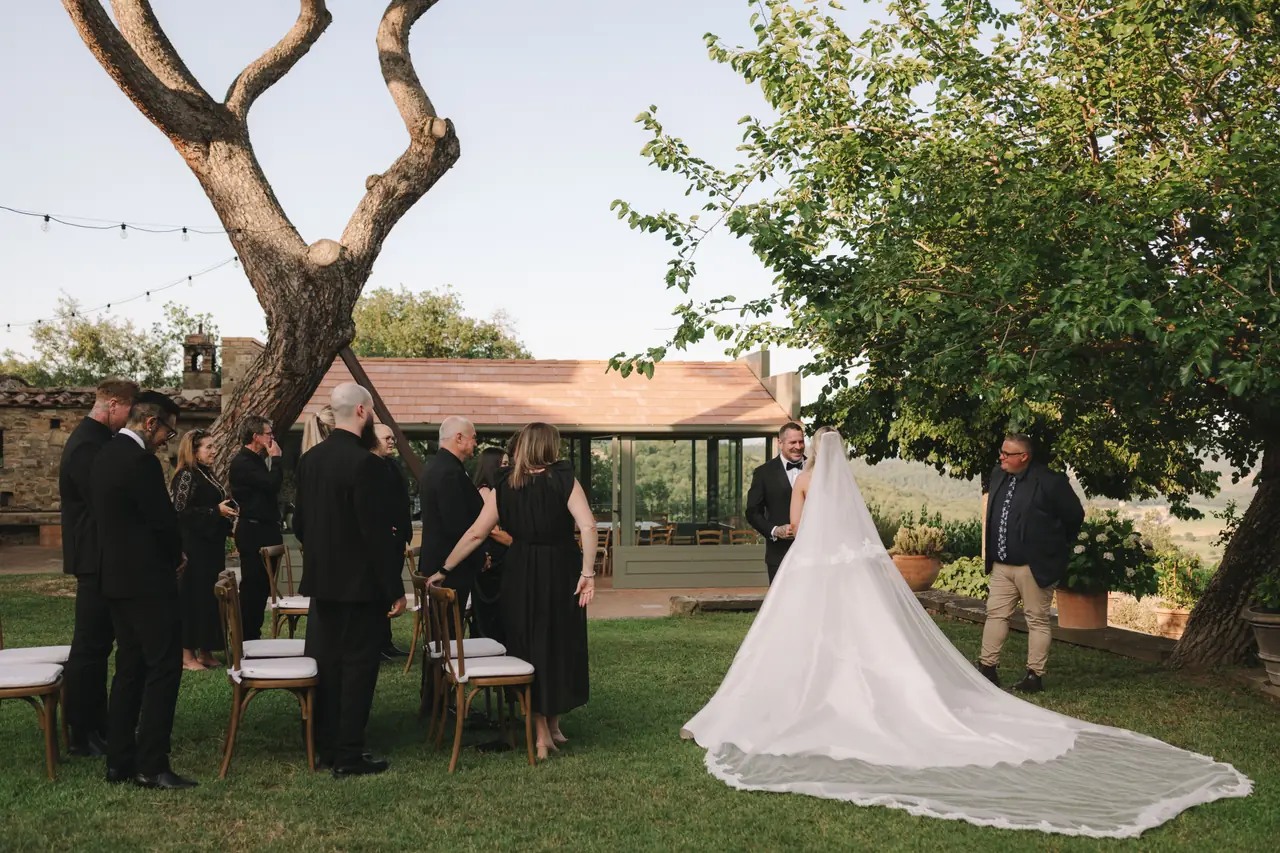 Isabella arrives at the garden ceremony as Anthony and their guests look on.