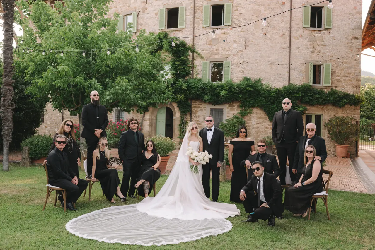 Anthony and Isabella stand with their wedding party outside the villa.